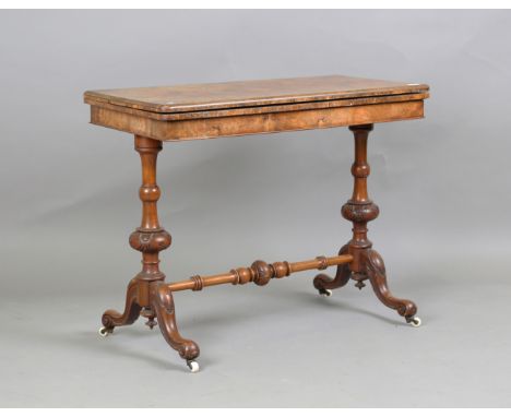 A mid-Victorian burr walnut rectangular fold-over card table, raised on a carved walnut base, height 73.5cm, width 94cm, dept