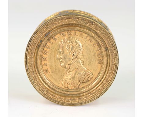A 19th century gilt metal cylindrical box and cover, the lid embossed with a portrait of 'Marquis Wellington', the base with 