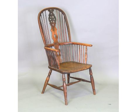 A mid-19th century yew, elm and ash Windsor armchair, the stick and wheel back above a shaped panel seat, height 112cm, width