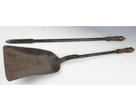 A pair of 19th century oversized iron and brass handled fire tools, comprising shovel and poker, length 90cm.Buyer’s Premium 