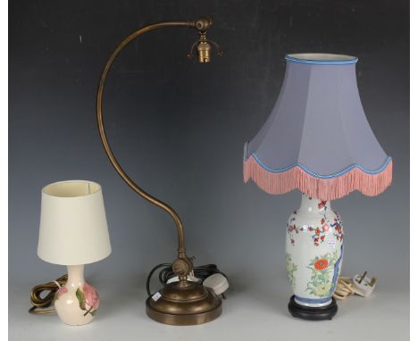 An early 20th century brass adjustable table lamp, height 59cm, a Chinese porcelain vase, converted to a table lamp, decorate