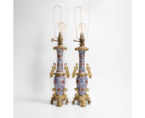 A pair of Chinese blue and white porcelain table lamps, Kangxi (1662-1722), each formed from a baluster vase and a gu vase, p