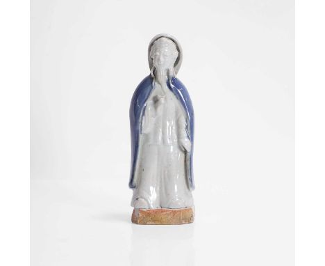 A Chinese export porcelain figure,  Qianlong (1736-1795), c.1740, of an immortal, standing wearing a long robe with an ingot 