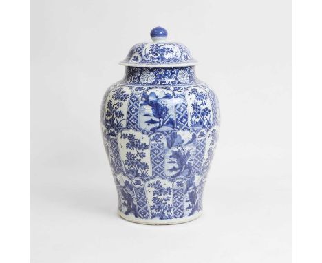 A Chinese blue and white vase and cover, Kangxi (1662-1722), of baluster form, painted with mountainous landscapes or flowers