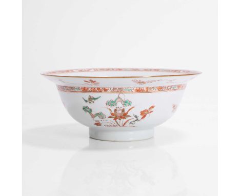 A Chinese wucai bowl, Kangxi (1662-1722), the rounded sides rising from a circular foot to a broad flared rim, the exterior p