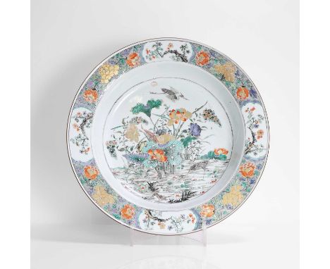 A Chinese famille verte basin, Kangxi (1662-1722), the rounded sides rising to a broad flared rim, the centre painted with eg