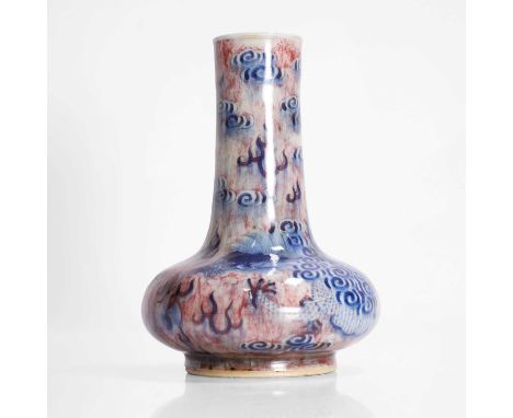 A Chinese copper-red and underglaze blue vase,  Republic period (1912-1949), the compressed globular body rising from a circu