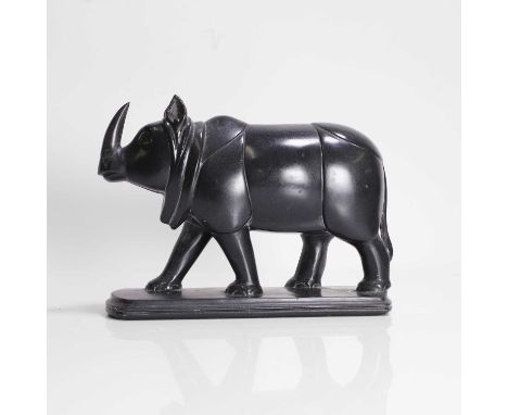 An Indian carved stone model of a rhinoceros, 19th century, possibly granite, modelled on a curved base, 23cm longCondition R