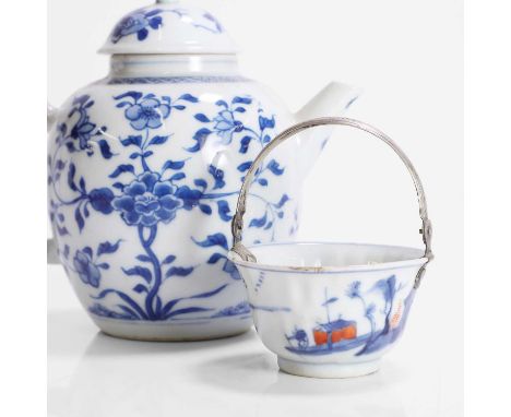A Chinese blue and white teapot, Kangxi (1662-1722), of ovoid form, painted with florets, the domed cover similarly decorated