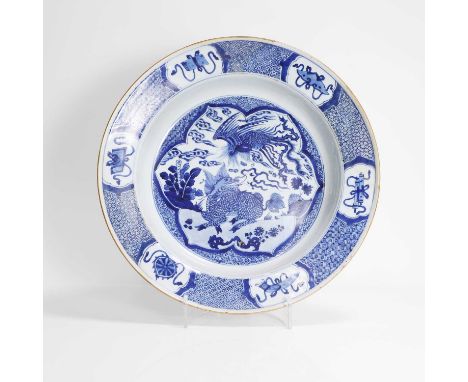 A Chinese export blue and white basin, Qing dynasty (1644-1911), of circular form with a broad flared rim, painted with a pho