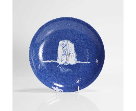A Chinese copper-red and underglaze blue plate, Kangxi (1662-1722), of circular form, painted with Damo wearing a long robe w