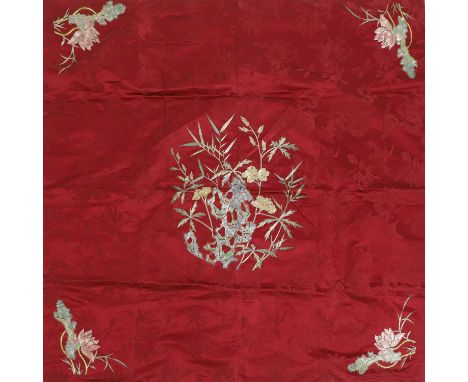 A Chinese embroidered tablecloth, 20th century, decorated with flowers by a rock to the centre, and with lotus to the four co