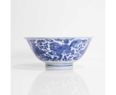 A Chinese blue and white bowl, Kangxi (1662-1722), the rounded sides rising from a circular foot to a flared rim, painted wit