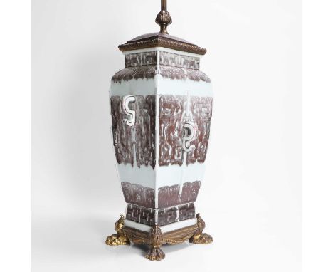 A Chinese copper-red vase, late Qing dynasty, in the shape of an archaic bronze, the tapering square body moulded with raised