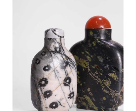 Two Chinese snuff bottles, Qing dynasty (1644-1911), plain, comprising:one in amygdaloidal basalt, the stopper with an agate 