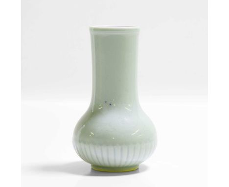 A Chinese celadon-glazed vase, Kangxi (1662-1722), the compressed globular body moulded with petals, rising to a straight nec