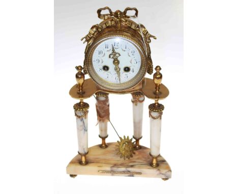 Gilt metal and marble French four pillar mantel clock with circular enamel and floral painted dial
