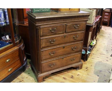 Georgian oak and chequer inlaid chest of two short above three long drawers on shaped bracket feet