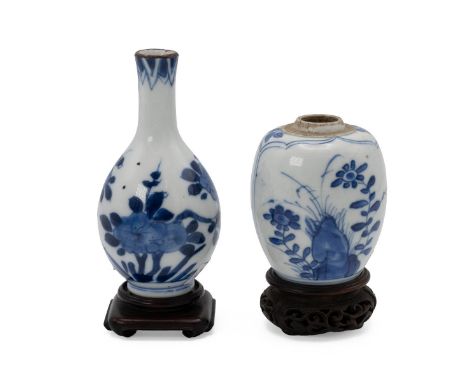 TWO SMALL CHINESE BLUE AND WHITE VASES ON STANDS, KANGXI, 18TH CENTURY  One of baluster form, decorated with flower motifs, 1