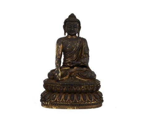 SINO-TIBETAN GILT BRONZE BUDDHA SHAKYAMUNI STATUE  Seated on a double lotus base with hands in Bhumisparsha Mudra. Traces of 