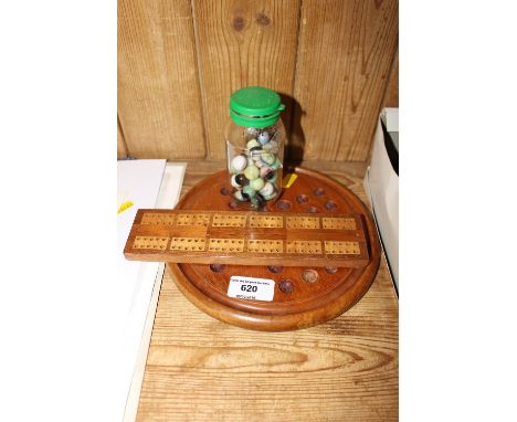 A Solitaire board and marbles and a Cribbage board