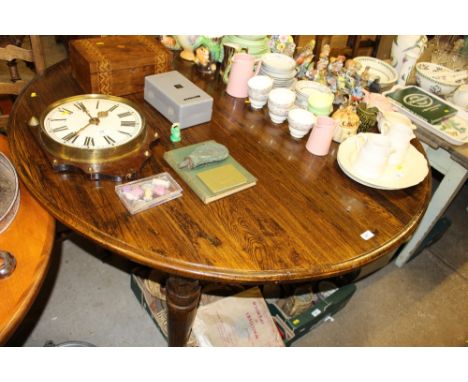 A good quality reproduction oak circular top dining table with five ladder back and rush seated dining chairs