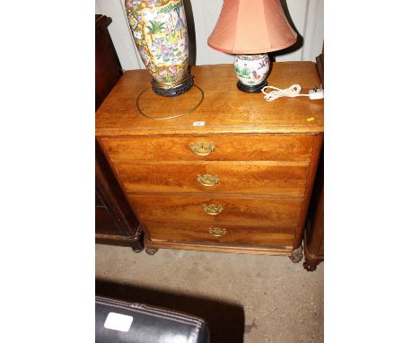 A light oak chest fitted four long drawers