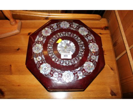 A red lacquered and mother of pearl inlaid octagonal box and cover 