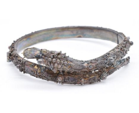 A late 19th/ early 20thC silver filigree bangle in the form of a dragon&nbsp;