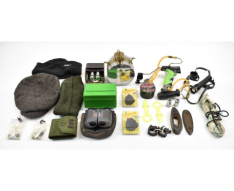 A collection of shooting accessories including two catapults and related ammunition, sectional hip-flask, Asian style powder 