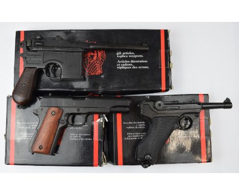 Three Denix replica pistols German Parabellum or Luger, US Army Model M1911 A1-67 and M96 Broom handled Mauser, all in origin
