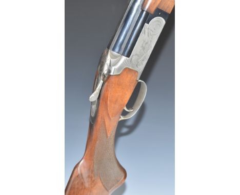 Winchester Select Field 12 bore over and under ejector shotgun with chequered semi-pistol grip and forend, engraved scenes of