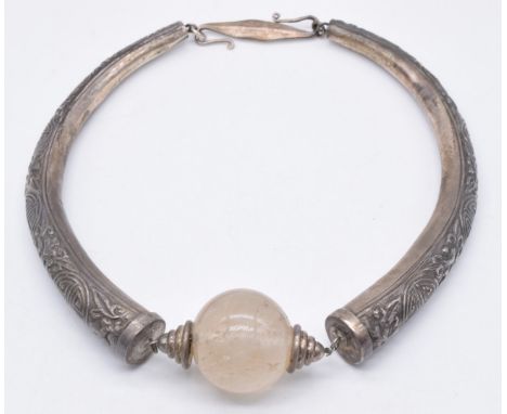 Chinese late 19thC silver necklace set with a rock crystal bead and decorated with embossed auspicious symbols&nbsp;