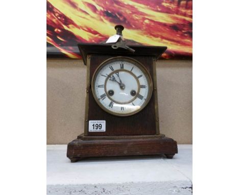 A brass mounted oak mantel clock