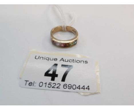 A 9ct gold ring set multigems in channel setting, size K
