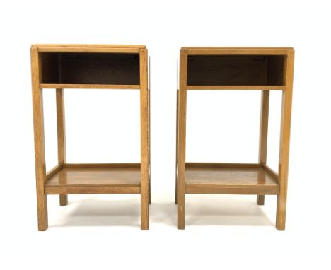Pair of 20th century Air Ministry light oak bedside table, with storage compartment, raised on square supports united by unde