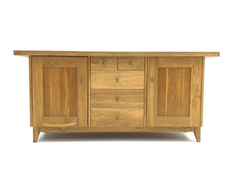 Modern solid light oak sideboard, rectangular top above two short and three long drawers, flanked by two panelled cupboards, 