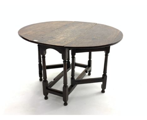 18th century oak drop leaf gate-leg table, oval top raised on turned supports with stretchers, 114cm x 99cm, H72cm Condition 