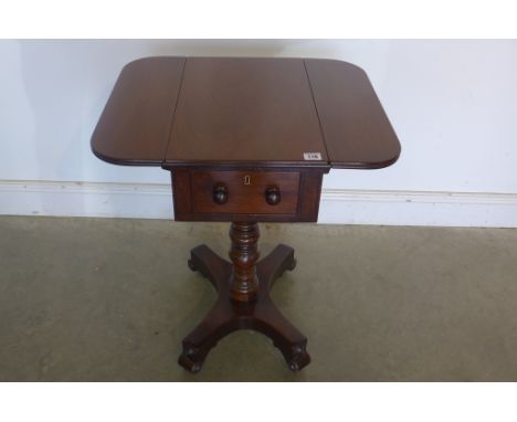 A 19th century mahogany work/lamp table with drop leaves and drawer supported on ring turned column and quadruped base, in re