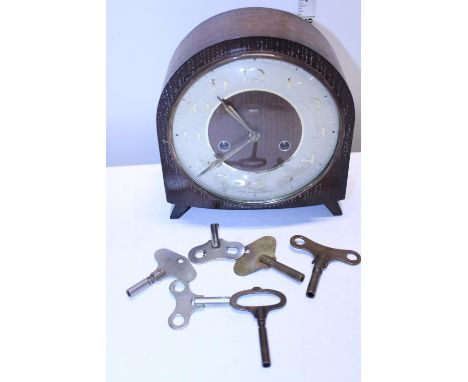 A wooden cased Smiths mantle clock with key in working order, shipping unavailable 