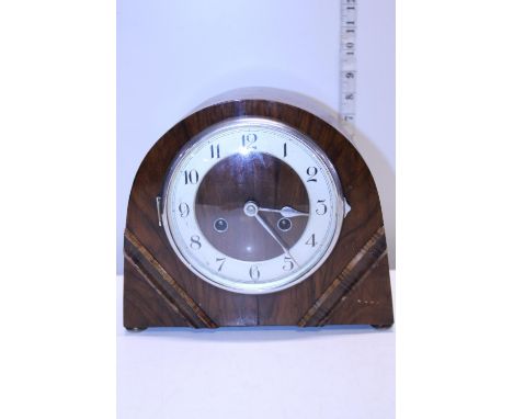 A working wooden cased mantle clock with key, shipping unavailable 