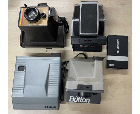 Five vintage Polaroid cameras plus a modern mini photo printer.
