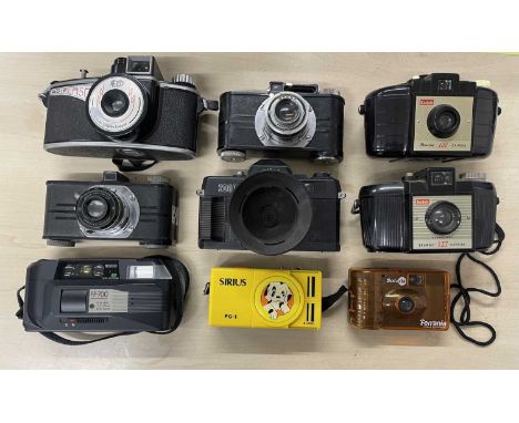 Nine vintage cameras to include: kodak Brownie 127 (x2); Argus; Salter Merit 2000; Sirius PG-1; Agilux AgiFlash; Argus ilex p