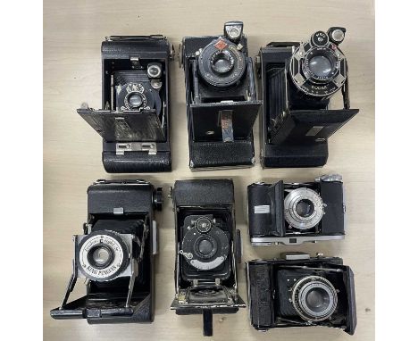 Seven vintage folding cameras to include: Kodak No. 1 Pocket; Kodak No. 0; Agfa; Zeiss Ikon; Baldinette; Kershaw Eight-20 and