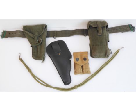 Three items of British Army equipment:a green canvas webbing comprising belt, holster and pouch;two Browning 9mm magazines in