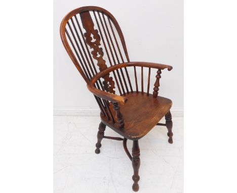 A mid-19th century comb-back Windsor armchair: yew wood bows and ornately pierced splat (with Christmas tree-style decoration