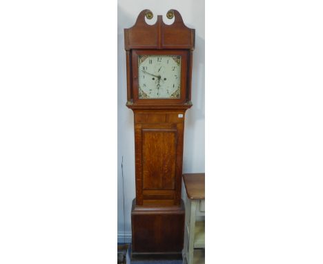 A 19th century thirty-hour oak longcase clock: the broken swan-neck pediment above a glazed hood with fluted pilasters and br