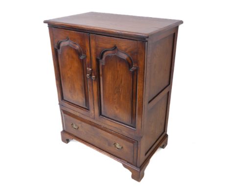 A good reproduction solid oak side cabinet: the two Moorish-style fielded panel doors opening to reveal shelf, single full-wi