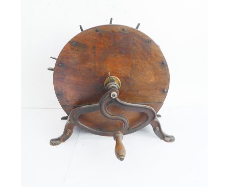 A 19th century oak and iron mounted circular knife cleaner with varying sized apertures and manual wind handle (ironwork brac