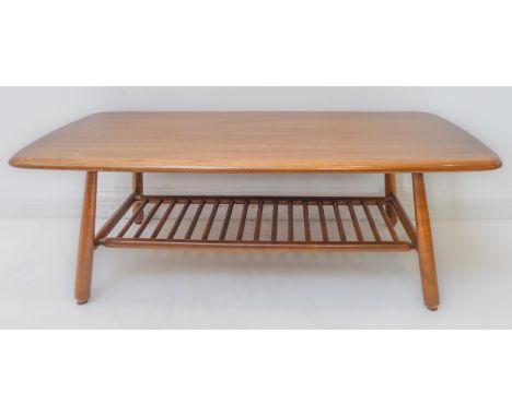 A good Ercol elm coffee table: figured top above four turned splayed legs united by a ladder-style stretcher (104cm wide x 50